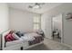Cozy bedroom featuring plush carpet, ceiling fan and an attached bathroom at 21840 N 260Th Ln, Buckeye, AZ 85396
