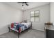 Bedroom with carpeted floors, ceiling fan, and a window at 21840 N 260Th Ln, Buckeye, AZ 85396