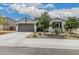 Charming single-story home featuring a two-car garage and desert landscaping at 21840 N 260Th Ln, Buckeye, AZ 85396