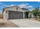 Home featuring a two-car garage, desert landscaping, and inviting curb appeal at 21840 N 260Th Ln, Buckeye, AZ 85396