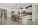 Modern kitchen with white cabinets, granite countertops, a spacious island, and stainless steel appliances at 21840 N 260Th Ln, Buckeye, AZ 85396