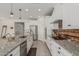 Bright kitchen featuring stainless steel appliances, granite countertops, and a large island with seating at 21840 N 260Th Ln, Buckeye, AZ 85396