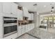 Contemporary kitchen with white cabinets, granite countertops, and stainless steel appliances at 21840 N 260Th Ln, Buckeye, AZ 85396