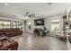 Open living area with a large sectional sofa, tile floors, and multiple windows for natural light at 21840 N 260Th Ln, Buckeye, AZ 85396