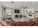 Spacious living room featuring tile floors, fireplace, large sectional sofa, and abundant natural light at 21840 N 260Th Ln, Buckeye, AZ 85396