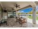 Covered patio has a dining table with view of pool and backyard at 21840 N 260Th Ln, Buckeye, AZ 85396