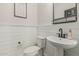 Charming powder room with shiplap accent, pedestal sink, and modern fixtures at 21840 N 260Th Ln, Buckeye, AZ 85396
