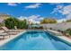 Cool swimming pool with a center umbrella and plenty of room for lounge chairs at 21840 N 260Th Ln, Buckeye, AZ 85396