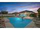Backyard featuring a pool, lounge chairs and desert landscaping at 21840 N 260Th Ln, Buckeye, AZ 85396