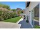 Landscaped backyard features lush green lawn, blooming shrubs, and views of nearby mountains at 2308 E State Ave, Phoenix, AZ 85020