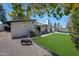 Backyard featuring a green lawn, patio seating, pool view, and landscaping at 2308 E State Ave, Phoenix, AZ 85020
