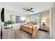 Cozy bedroom showcases a metal bed frame, stylish decor, a ceiling fan and natural light at 2308 E State Ave, Phoenix, AZ 85020