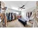 Spacious walk-in closet featuring ample storage, custom shelving and a stylish seating bench at 2308 E State Ave, Phoenix, AZ 85020