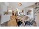 Open dining area adjacent to kitchen features wooden table, modern lighting and decor at 2308 E State Ave, Phoenix, AZ 85020