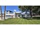 Beautiful modern house featuring a 3 car garage, a second story deck, and a manicured lawn at 2308 E State Ave, Phoenix, AZ 85020
