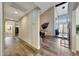 Hallway featuring wood floors, high ceilings, access to the dining room, and views to the outside at 2308 E State Ave, Phoenix, AZ 85020