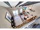 Open living room featuring a fireplace, TV, stylish decor, and high ceilings with exposed beams at 2308 E State Ave, Phoenix, AZ 85020