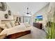 Spacious main bedroom with a ceiling fan, TV, and French doors to the backyard at 2308 E State Ave, Phoenix, AZ 85020