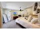 Large main bedroom with soft carpet, ceiling fan, and en-suite bathroom at 2308 E State Ave, Phoenix, AZ 85020