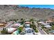 Picturesque neighborhood view with desert mountain backdrop, lush landscaping, and variety of home styles at 2308 E State Ave, Phoenix, AZ 85020