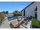 Backyard pool and patio features lounge chairs and black umbrellas, perfect for relaxation and entertaining at 2308 E State Ave, Phoenix, AZ 85020
