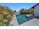 Relaxing backyard pool area with blooming flowers, blue tile accents, and comfortable lounge seating at 2308 E State Ave, Phoenix, AZ 85020