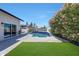 Pool surrounded by a lush green yard and blooming flowers, creating a serene outdoor space at 2308 E State Ave, Phoenix, AZ 85020