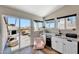 Modern wet bar with granite countertops, white cabinets, and a view of the outdoor patio at 2308 E State Ave, Phoenix, AZ 85020