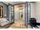 Open French doors provide views from the home office to the foyer, laundry, and interior design elements at 27067 W Sequoia Dr, Buckeye, AZ 85396