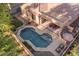 Aerial view of a pool, outdoor kitchen, covered patio, and well-maintained yard at 4554 S Cobblestone St, Gilbert, AZ 85297