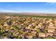 Expansive aerial view of a suburban community with lush greenery and beautiful mountain views in the distance at 4554 S Cobblestone St, Gilbert, AZ 85297