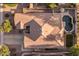 The aerial shot highlights the home's roof, driveway, and landscaping in a quiet neighborhood at 4554 S Cobblestone St, Gilbert, AZ 85297