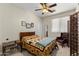 Bedroom with ceiling fan, decorative blanket, and seating area at 4554 S Cobblestone St, Gilbert, AZ 85297