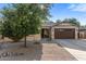 Inviting single story home with desert landscaping, mature shade tree, and covered entryway at 4554 S Cobblestone St, Gilbert, AZ 85297