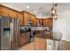 Open kitchen with stainless steel refrigerator, stone countertops, and modern appliances at 4554 S Cobblestone St, Gilbert, AZ 85297