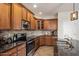 Beautiful kitchen featuring stone countertops, modern appliances, and tile flooring at 4554 S Cobblestone St, Gilbert, AZ 85297