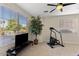 Bright living room featuring a large window and a variety of exercise equipment at 4554 S Cobblestone St, Gilbert, AZ 85297