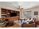 Inviting living room featuring custom built-ins, hardwood floors, and large window at 4554 S Cobblestone St, Gilbert, AZ 85297