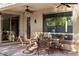 Covered patio showcases an outdoor dining area with comfortable seating and a ceiling fan at 4554 S Cobblestone St, Gilbert, AZ 85297