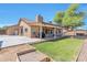 Relaxing backyard featuring lush lawn, covered patio, and barbecue area, perfect for outdoor gatherings at 6102 W Shangri La Rd, Glendale, AZ 85304