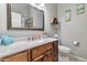 Cozy bathroom with updated vanity, modern toilet and decorative mirror at 6102 W Shangri La Rd, Glendale, AZ 85304