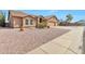Street view of a charming single-story home featuring a well-maintained yard and a spacious two-car garage at 6102 W Shangri La Rd, Glendale, AZ 85304