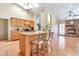 Open-concept kitchen features skylight, an island with seating, and neutral color palette at 6102 W Shangri La Rd, Glendale, AZ 85304