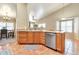 Bright kitchen featuring terracotta tile flooring, wood cabinets, and stainless steel appliances at 6102 W Shangri La Rd, Glendale, AZ 85304