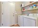 Bright laundry room featuring white washer and dryer and access door at 6102 W Shangri La Rd, Glendale, AZ 85304