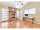 Living room features a brick fireplace, ceiling fan and natural light at 6102 W Shangri La Rd, Glendale, AZ 85304