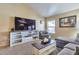 Comfortable living room with a large TV and plenty of seating at 6102 W Shangri La Rd, Glendale, AZ 85304