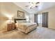 Spacious main bedroom with ceiling fan, ensuite bathroom and large window at 6102 W Shangri La Rd, Glendale, AZ 85304