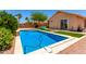 Backyard pool features artificial turf, desert landscaping, and a sparkling swimming pool at 6557 S Classic Way, Gilbert, AZ 85298
