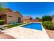 Inviting backyard with a sparkling pool, comfortable lounge chairs, and well-maintained desert landscape at 6557 S Classic Way, Gilbert, AZ 85298